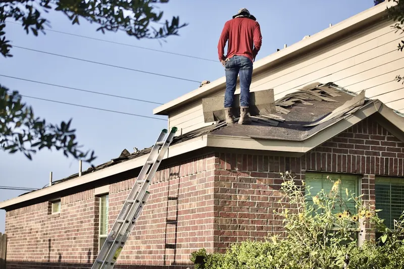 Professional roofer working on a residential roof in Highland Park Arlington